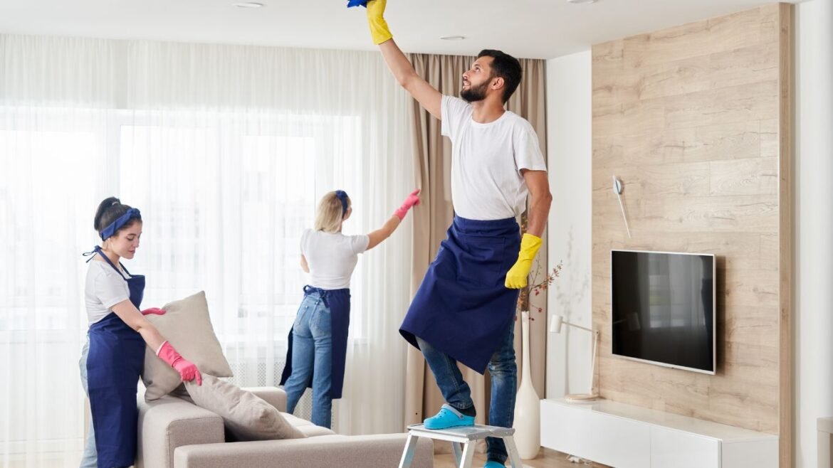 Professional apartment cleaning team working in Abu Dhabi living room