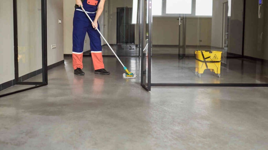 Professional cleaners performing monthly house cleaning service in Abu Dhabi living room.