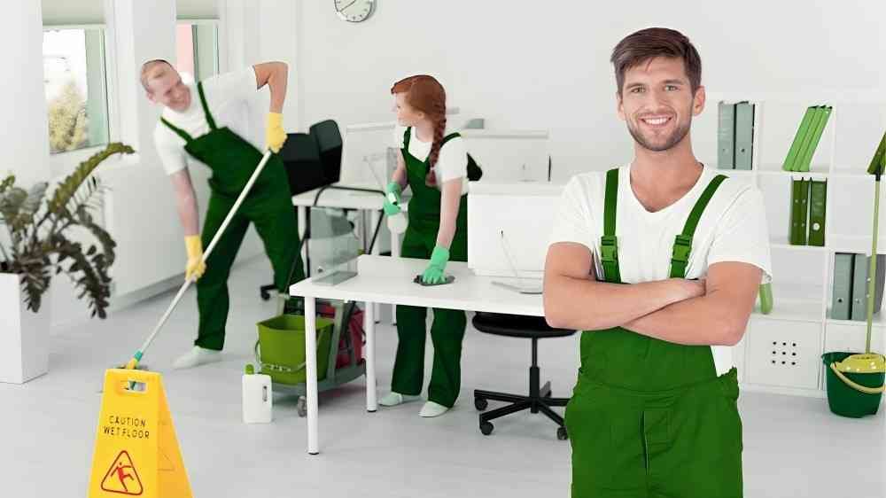 Professional staff performing deep office cleaning service for office desks